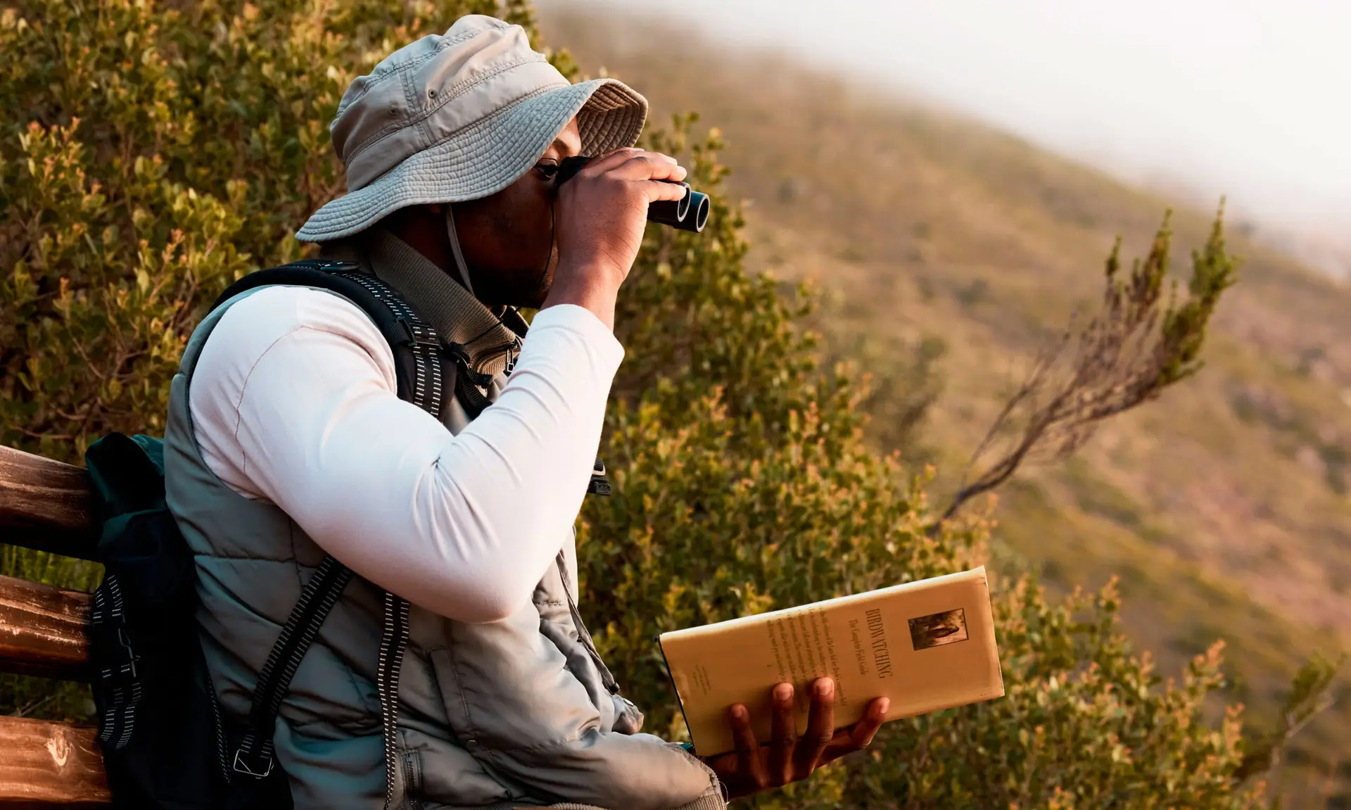Boy using binoculars to observe birds in their natural habitat in San Martín de los Andes